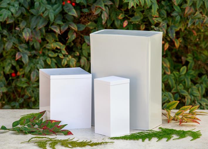 three white rectangular plastic urns